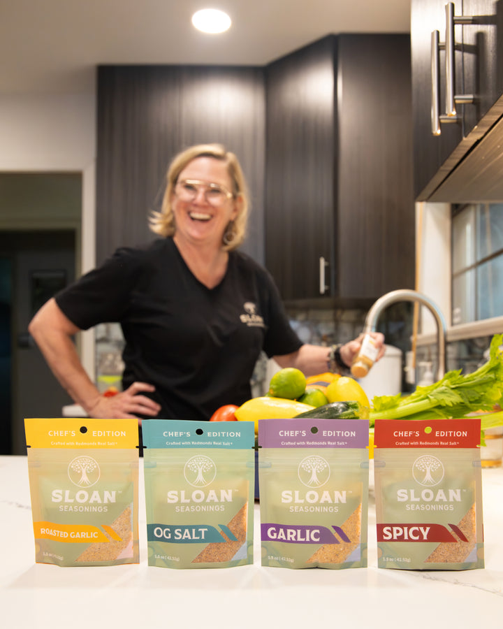 Sloan Seasonings founder with Chef's Edition 4 pack seasonings salt bags in kitchen